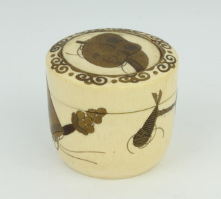 A Meiji period Japanese turned ivory cylindrical box with lacquered decoration the lid with a mask 4.5cm 