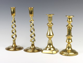 A pair of 19th Century brass spiral turned candlesticks together with 2 other 19th Century brass candlesticks 
