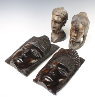 Two African carved wooden portrait busts of ladies 24cm x 13cm x 8cm together with 2 ditto carved wall masks 33cm x 20cm 