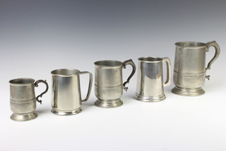 A victorian pewter quart measure and 4 pewter tankards 
