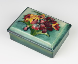 A Moorcroft rectangular box and cover decorated with flowers, with signature, impressed mark and paper to the late Queen Mary label 11cm w