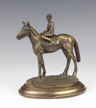 A bronzed figure of a race horse with jockey up, raised on an oval base 15cm h 