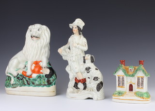 A Victorian money box in the form of a country cottage 11cm, a ditto group of a gentleman and spaniel 25cm and a ditto of a lion astride a man 24cm 