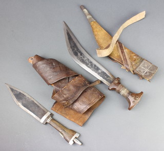 An African double edged dagger with 20cm glade and wooden grip contained in a leather scabbard with belt together with a crescent shaped ditto 32m 