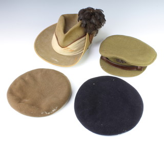 A South African military slouch/side hat with hackle and a Middlesex Officer's service dress cap by Herbert Johnson, a brown beret by Lott and Co. and a military issue Royal Artillery beret 