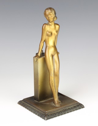 Lorenzl, an Art Deco spelter table lighter in the form of a standing naked lady raised on square base 18cm x 10cm x 10cm 

