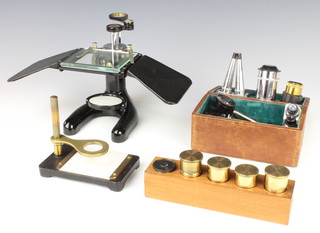 A Flatters and Garnett Ltd microscope together with a collection of various lenses 