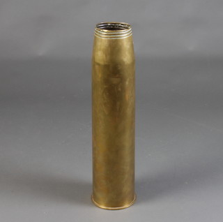 A large brass shell case marked 45 Inmks 3-5 gun, dated 1957 
