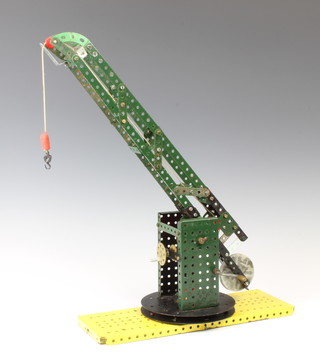 A red and green Meccano working model of a crane 34cm h x 11cm 
