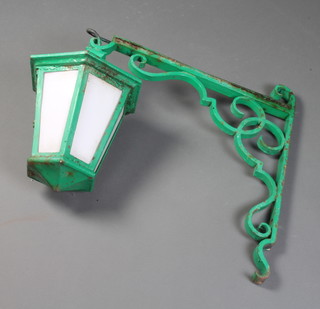 A hexagonal green painted iron hanging lantern 30cm x 34cm with wrought iron bracket 64cm h 