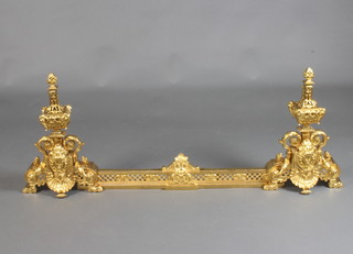A French gilt metal Rococo style fire curb with 2 pierced gilt metal end irons in the form of lidded urns 50cm w x 13cm h x 13cm d 