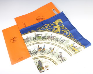 Hermes, a lady's silk headscarf, the centre marked La Promenade De Longchamps 87cm x 87cm together with a Hermes envelope and carrier bag