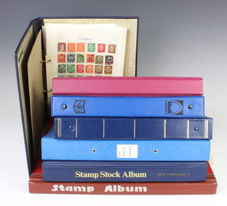 Six albums of world stamps together with a stock book of world stamps 