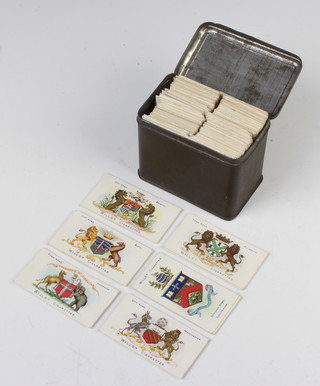 A small collection of cigarette cards contained in a metal tin, mostly Wills 