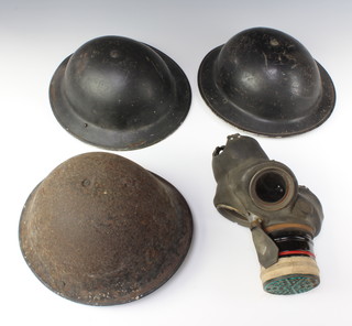 A WWII steel helmet marked HF 1939 JSS complete with liner together with 1 other marked A38? complete with liner, a 1950's steel helmet complete with liner and a WWII Civil Defence respirator 