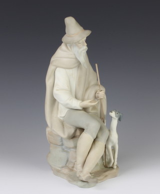 A Lladro matt figure of a seated gentleman with hound at his feet 27cm 