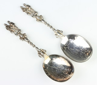 A pair of Victorian silver serving spoons with figural handles London 1897 and 1898, 135 grams