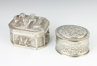 An Indian repousse silver octagonal rectangular trinket box decorated with figures 9cm and an oval ditto 8cm, 295 grams