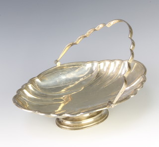 A scallop silver basket with swing handle raised on an oval pedestal foot 500 grams 