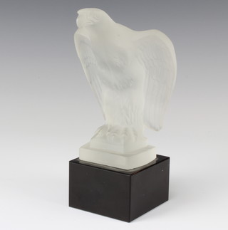 A moulded glass figure of an eagle raised on a square black base 22cm 