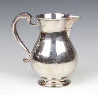 A silver Georgian design jug with S scroll handle London 1913, 18cm, maker Herbert Charles Lambert, 722 grams 