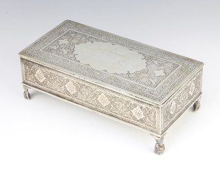 A Persian silver rectangular cigarette box decorated with exotic birds amongst flowers with vacant cartouche on figural feet, 20cm, 652 grams