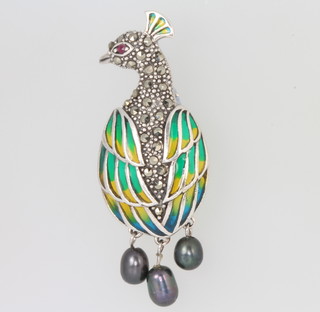 A silver, enamel, marcasite, ruby and black pearl brooch in the form of a peacock 5cm 