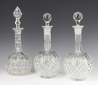 A pair of mallet shaped decanters and stoppers 28cm and a ditto 32cm 