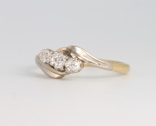 An 18ct yellow gold 3 stone diamond crossover ring 2.4 grams, size J 1/2