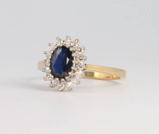 An 18ct yellow gold oval sapphire and diamond cluster ring, 3 grams, size K 1/2