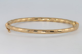 A 9ct yellow gold engine turned bangle 4.7 grams