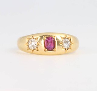 An 18ct yellow gold ruby and diamond gypsy ring, 4.6 grams, size N 1/2