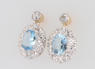 A pair of 9ct yellow gold oval aquamarine and diamond drop earrings, the centre stones approx. 2.5ct surrounded by brilliant cut diamonds 1.5ct 
