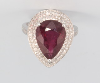 A 14ct white gold pear cut ruby and diamond cluster ring, the centre stone approx. 7.43ct, surrounded by brilliant cut diamonds approx. 0.6ct size M 1/2