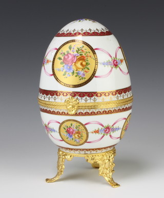 A 20th Century painted porcelain, gilt metal mounted egg decorated with spring flowers 23cm 