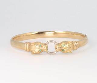 A 9ct yellow gold diamond set double leopard head bangle with emerald eyes, 11.6 grams 