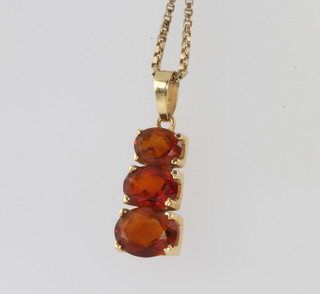A 9ct yellow gold garnet 3 stone pendant on a ditto chain together with 2 9ct yellow gold rings, gross weight 12 grams 