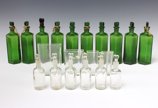 A collection of green and clear glass chemists bottles 