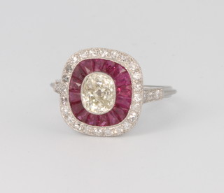 A platinum, diamond and ruby Art Deco style ring with centre old cut diamond approx. 1ct in total and tapered rubies approx 1.15ct, size K 1/2
