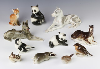 A Russian porcelain figure of a reclining dog 25cm and 10 other figures 