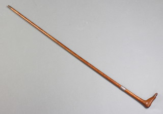 A walking cane, the handle carved in the form of a foot  