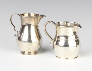 An Edwardian Georgian style silver cream jug, London 1902, a baluster ditto 246 grams
