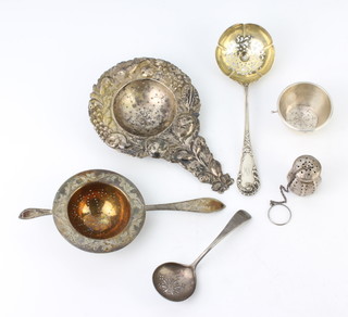 A sterling silver sifter spoon, two strainers and minor items, 235 grams