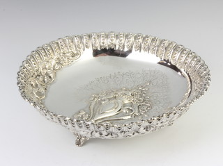 A Continental repousse silver bowl decorated with a vase of flowers, raised on scroll feet, 390 grams, 26cm 