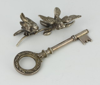 A silver presentation key together with a group of 2 silver birds 118 grams