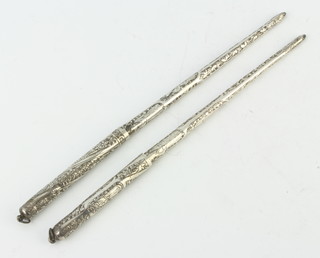 Two silver engraved quill pens, 37 grams