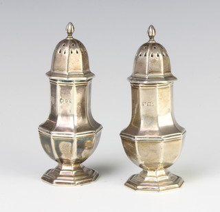 A near pair of octagonal silver pepperettes, 100 grams