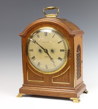 Maple and Co., a Georgian style double fusee bracket clock with 20cm dial and 15cm back plate, striking on a gong, contained in arched light oak and brass case  