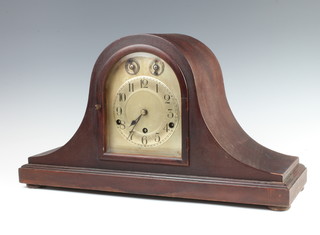 A German 8 day striking mantel clock with arched silvered dial and Arabic numerals, strike/chime dial, contained in a mahogany Admiral's hat shaped case