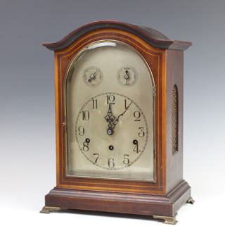 A German bracket clock, striking on a gong, with arched silvered dial contained in an inlaid mahogany case 